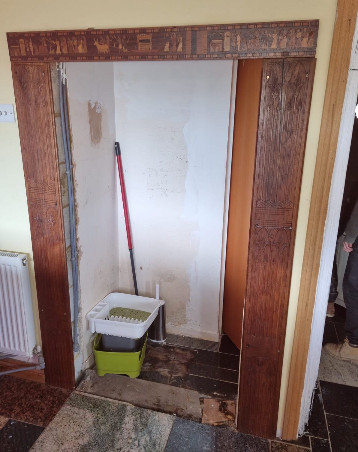 A panelled oak door with inset stained glass panels, width 78cm, height 194cm, another panelled door, sundry framework and assorted columns